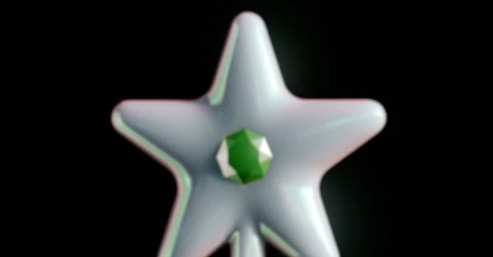 The Wand’s star and green gem, close up, on black
